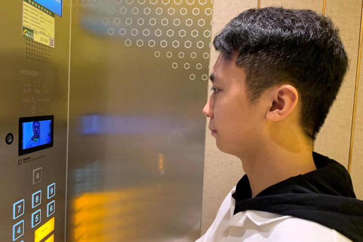 A staff member has his face scanned at an elevator during a demonstration to the media at Alibaba Group's futuristic FlyZoo hotel in Hangzhou, Zhejiang province, China January 22, 2019. 