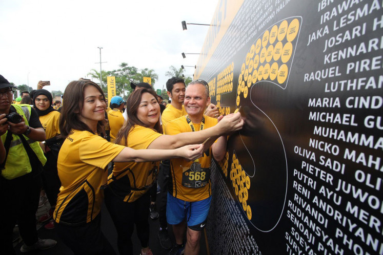 Say cheese: Sun Life Financial Asia President Claude Accum (right) poses for a photograph with (from left right) Sun Life Financial Indonesia Chief Marketing Officer Shierly Ge and Sun Life Financial Indonesia President Director Elin Waty during the 2019 Sun Life Resolution Run at ICE BSD, South Tangerang, on Sunday.