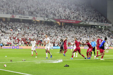 Bitter rivals: Fans throw bottles and flip-flops onto the pitch during the 2019 AFC Asian Cup semifinal soccer match between Qatar and the United Arab Emirates at the Mohammed Bin Zayed Stadium in Abu Dhabi on Tuesday. Qatar won 4-0 to face Japan in Friday’s final.
