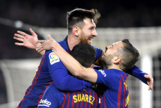 Group hug: Barcelona's forward Lionel Messi (left) celebrates with teammates forward Luis Suarez and defender Jordi Alba after scoring in the Copa del Rey quarterfinal second leg soccer match against Sevilla at the Camp Nou stadium in Barcelona in this file photo. 