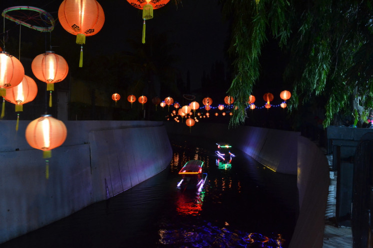 Boats cruise the Pepe River under lanterns during a lantern festival to celebrate Chinese New Year in Surakarta, Central Java