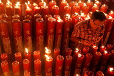 Light the way: A man lights candles at Dharma Ramsi temple in Bandung, West Java. JP/Arya Dipa
