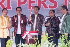 Free but responsible press: President Joko Widodo (center) strikes a 'tifa', a traditional Maluku drum, during the opening of the National Press Day celebrations in Ambon, Maluku on Feb. 9, 2018. Next year, Jakarta will host the event.