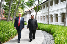 First date: North Korea’s leader Kim Jong-un (right) walks with United States President Donald Trump as they take a break during their talks at the historic US-North Korea summit, at the Capella Hotel on Sentosa Island in Singapore, in June 2018.