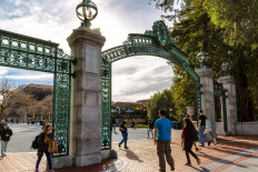 Students enter the campus of the University of California at Berkeley through the main entrance, Sather Gate.