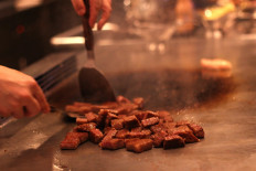 Close up of cooking gourmet Miyazaki beef on a teppan