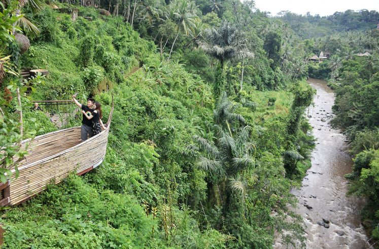 Tourists take a wefie in Bongkasa village, Badung regency, Bali, in 2019. 