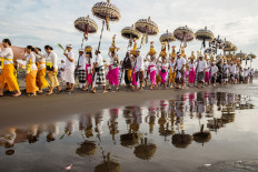Purification: Balinese Hindus parade along Lembeng Beach in Gianyar, Bali, during Melasti, a purification ceremony, ahead of the holy day of Nyepi.