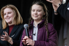 16 year-old Swedish climate activist Greta Thunberg (C) and Belgian students gather to call for urgent measures to combat climate change during a demonstration in Brussels, Belgium, on February 21, 2019. 