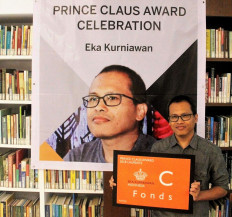 All smiles: Author Eka Kurniawan poses with his Prince Claus Award certificate during an event held by Dutch Ambassador to Indonesia Rob Swartbol in Jakarta. 