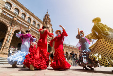 Young women dance flamenco on Plaza de Espana, Seville, Spain