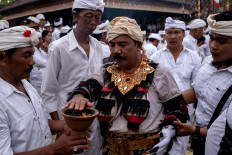 A Balinese leader touches fire while wearing a sacred Rangda. JP/Agung Parameswara
