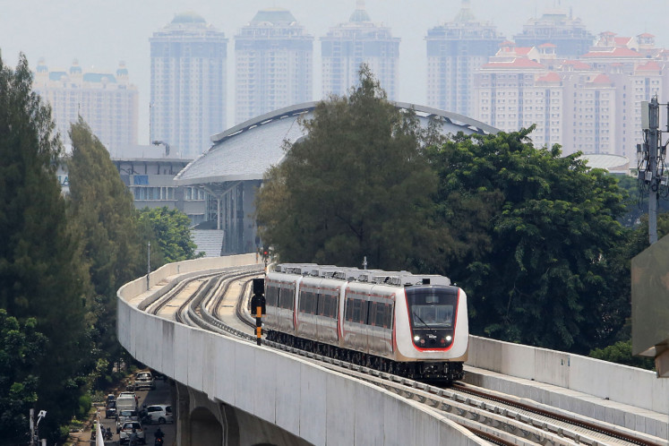 A light rail transit (LRT) train is pictured on a trial run from Kelapa Gading to Rawamangun Velodrome in Jakarta on Monday. The LRT is expected to begin operation in March with a month of delay.
