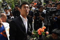 Banned Thai billionaire politician vows to press fight for democracy