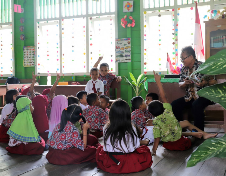 Story time: Kuleh Lenjau reads a story to the class; a favorite time in the school day