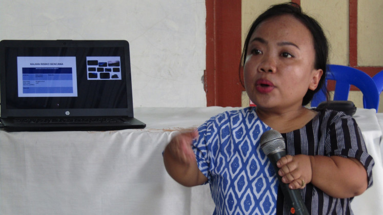 Anggiasari Puji Aryatie, 39, a NasDem Party legislative candidate, gives a presentation about disaster risks in  kampung Bausasran in Yogyakarta.