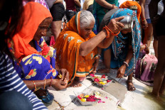 Holy pour: A group of women celebrate on the banks of the Ganges. JP/PJ Leo