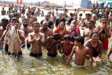 Time for a dip: Devotees take part in a holy ritual and pray. JP/PJ Leo