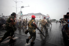Dutch military reenactors attack mock Indonesian independence fighters during the performance. JP/Boy T. Harjanto