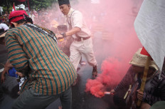 Indonesian military reenactors pass through smokes during a reenactment of the offensive. JP/Boy T. Harjanto