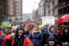 People take part in a march in support of the climate, on March 10, 2019 in Amsterdam, asking for climate action by politics and corporates. 