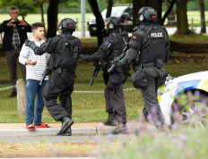 AOS (Armed Offenders Squad) push back members of the public following a shooting at the Masjid Al Noor mosque in Christchurch, New Zealand, March 15, 2019. 