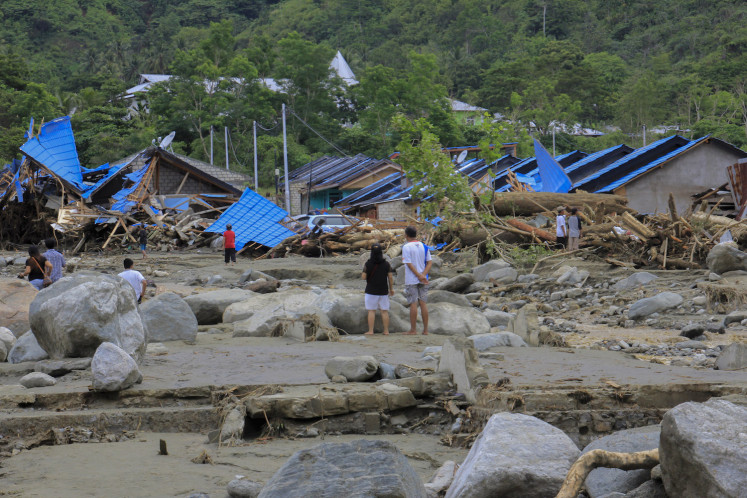 Residents examine their wrecked homes  after flooding in Sentani, Jayapura, Papua on Sunday. Some 50 people are believed to have lost their lives in the deluge.