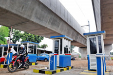 A motorcyclist recently rides through the gates of a park-and-ride facility under the MRT station in Lebak Bulus, South Jakarta.