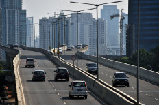 Vehicles drive on a flyover in downtown Jakarta on June 25, 2015. 