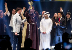 This handout picture provided on March 24, 2019 by the Global Education and Skills Forum, an initiative of the Varkey Foundation, shows Kenyan teacher Peter Tabichi (C) holding up the Global Teacher Prize (GTP) trophy after winning the US$ 1 million award during an official ceremony in Dubai presented by Australian actor Hugh Jackman (C-L) and attended by the Dubai Crown Prince Hamdan bin Mohammed Al-Maktoum (C-R). 