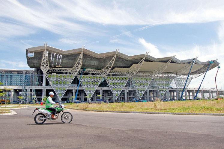 Facility inspection: A worker rides a motorbike past Kertajati International Airport on March 28, 2018, while still under construction, in Majalengka, West Java. 