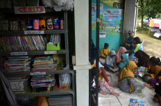 Children are seen enjoying their spare time at the community library.