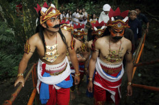 Marching on: Residents wearing traditional Javanese costumes climb Tidar Hill. JP/Magnus Hendratmo
