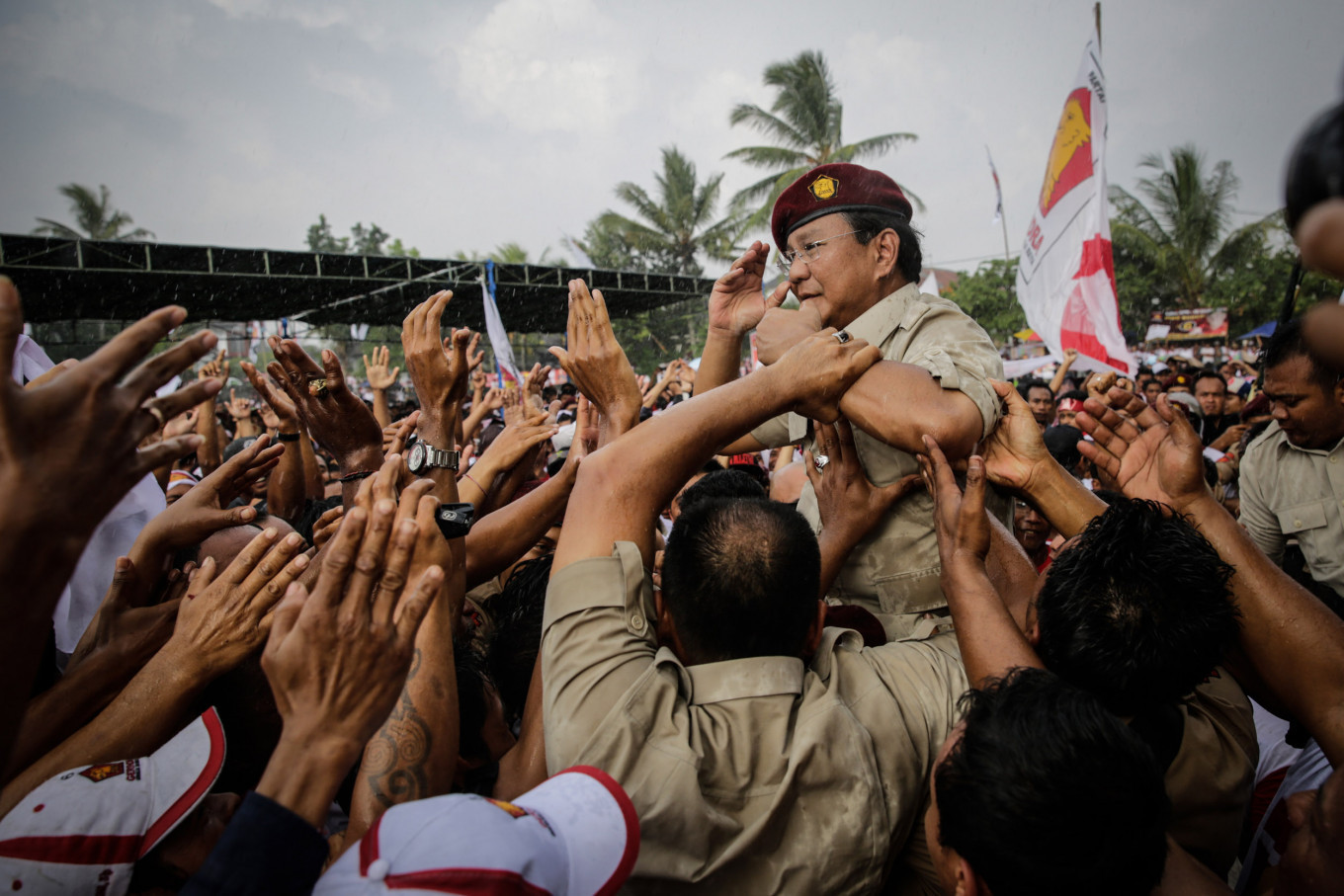 Prabowo Subiyanto (center) smiles in the middle of crowd after he speak to supporters during the Gerindra Party campaign rally in Tabanan, Bali on Monday 17 March 2014. The Gerindra Party became the leading opposition party after the 2014 general election. 