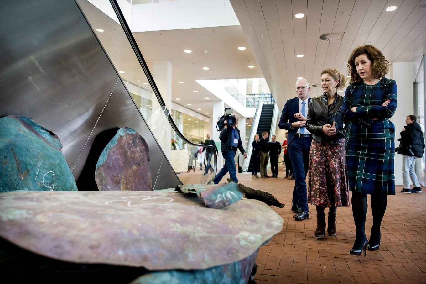 Dutch minister of Culture Ingrid van Engelshoven (R) stands in front of copper plates from a ship wreck from 1536 that was discovered during the storage of the containers that were lost of the MSC Zoe vessel earlier this year, in Amersfoort, on April 3, 2019. The container carrier MSC Zoe caught on January 2, 2019 in rough North Sea weather lost at least 270 containers.