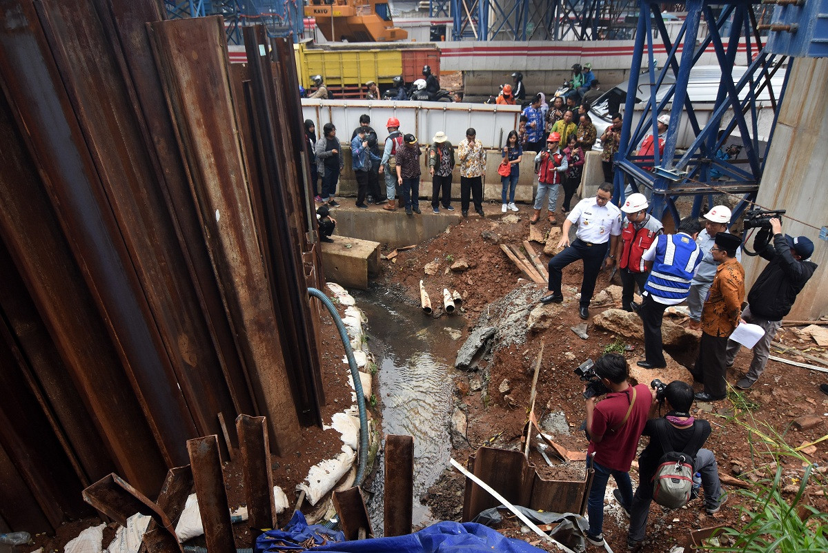 Jakarta Governor Anies Baswedan (center) visits a flooded area located next to an LRT project site at Cawang underpass in Jakarta on April 4, 2019.