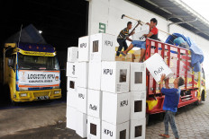 Workers load boxes containing election materials onto a truck at a warehouse belonging to the Jember General Elections Commission in East Java on Tuesday. 