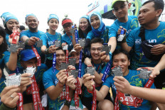 Proud achievement: Amateur runners show their finisher medals at a running event in Tangerang, Banten, last December.