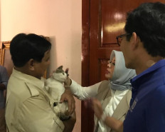 Former presidential candidate Prabowo Subianto holds his pet Bobby the Cat during their visit on the afternoon of April 17 to Sandiaga Uno and his wife's room in a house on Jl. Kertanegara in South Jakarta that was used by the pair's campaign team as their base camp .