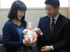 Six-month-old Ryusuke Sekiya (C) is pictured with his parents one day before his scheduled discharge from a hospital in Azumino, Nagano prefecture on April 19, 2019. Ryusuke Sekiya was born on October 1, 2018, as the world's smallest baby boy via an emergency Caesarean section, weighing only 258 grams (9.1 ounces) after 24 weeks and five days of pregnancy as his mother Toshiko experienced hypertension.