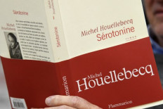 A man reads the book 'Serotonine', written by French writer Michel Houellebecq and published by Flammarion, in Paris, on January 3, 2019. 
