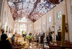 Fatal attack: Crime scene officials inspect the site of a bomb blast inside a church in Negombo, Sri Lanka, on Sunday. 