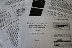 An illustration shows printed pages of the redacted Mueller Report at an office on April 18, 2019, in Washington, DC. 