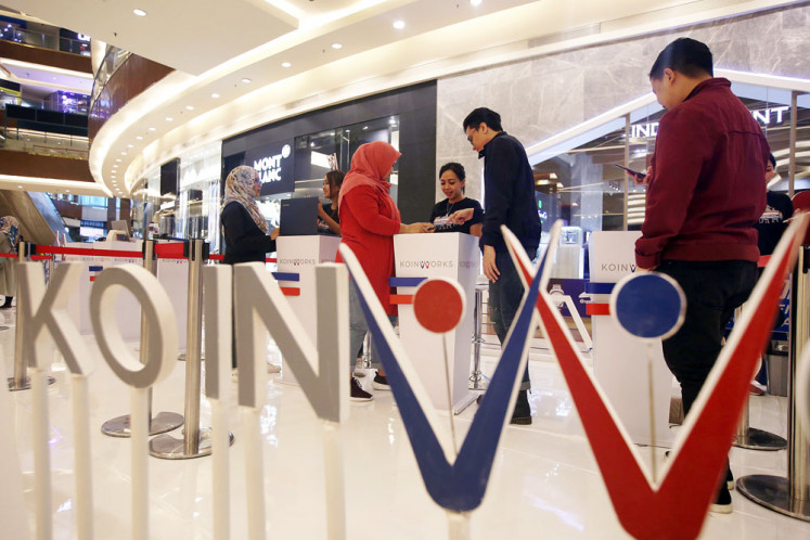 People are given information about services from online lending company KoinWorks in Jakarta in April 2019.