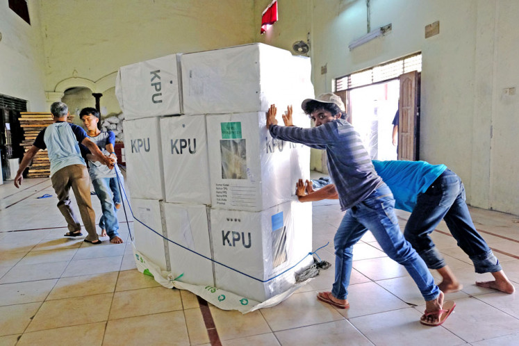 Push and pull: People move ballot boxes sent in from various districts during the 2019 presidential and legislative elections at the General Elections Commission (KPU) office in Magelang, Central Java. 