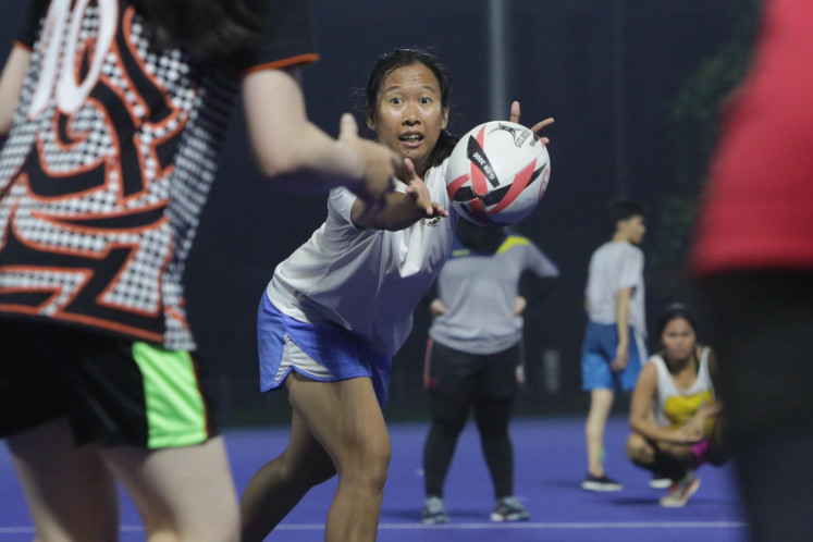 Leader of the herd: Team captain Kartika Esi makes eye contact with a teammate as she passes the ball. 
