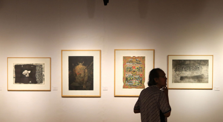 Looking around: A visitor enjoys graphic artworks during the Triennial Graphic Arts Indonesia exhibition at the Bentara Budaya complex in Jakarta.