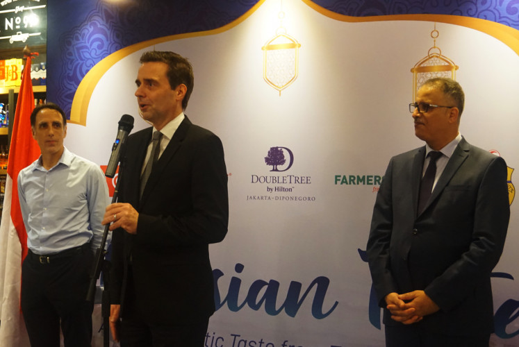 COO of PT Supra Boga Lestari Gilles Pivon (left), general manager of DoubleTree by Hilton Jakarta-Diponegoro Nils-Arne Schroeder (center) and Tunisian Ambassador to Indonesia Riadh Dridi during the opening ceremony of Tunisian Taste on Friday at Ranch Market in Grand Indonesia Mall, Central Jakarta.  