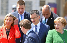 Bandwagon: Austrian Chancellor Sebastian Kurz (front center), European Union High Representative for Foreign Affairs and Security Policy Federica Mogherini (left), Slovenia’s Prime Minister Marjan Sarec (center), German Chancellor Angela Merkel (right), Estonian Prime Minister Juri Ratas (top left) and Bulgarian Prime Minister Boyko Borissov prepare to pose for a family photo during the informal meeting of European Union leaders in Sibiu, Romania, on Thursday.