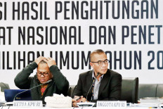 General Elections Commission (KPU) chairman Arief Budiman (left), along with member Hasyim Asy’ari, leads a plenary meeting on the vote counting process on May 14, 2019 at the poll body’s office in Central Jakarta. 
